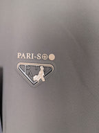Prada jacket fabric close-up with PARI-SO logo and triangular emblem