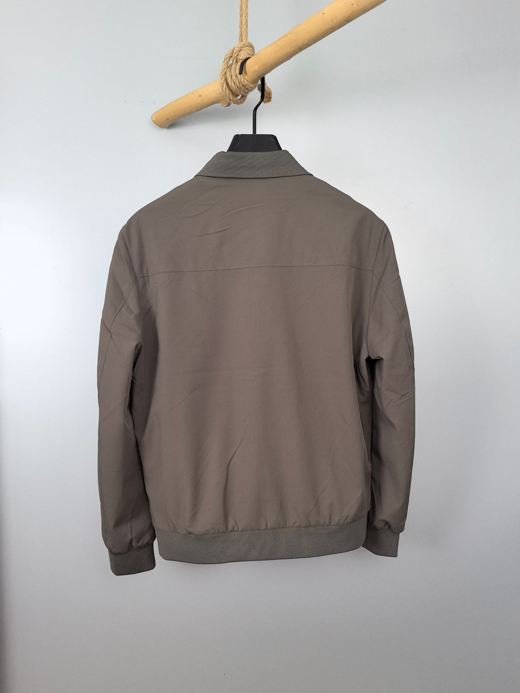 Men's Prada long-sleeve zip jacket, back view in taupe with ribbed hem