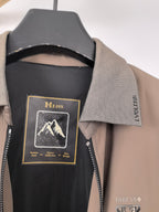 Men's Prada jacket neck label close-up with black inner lining and taupe collar