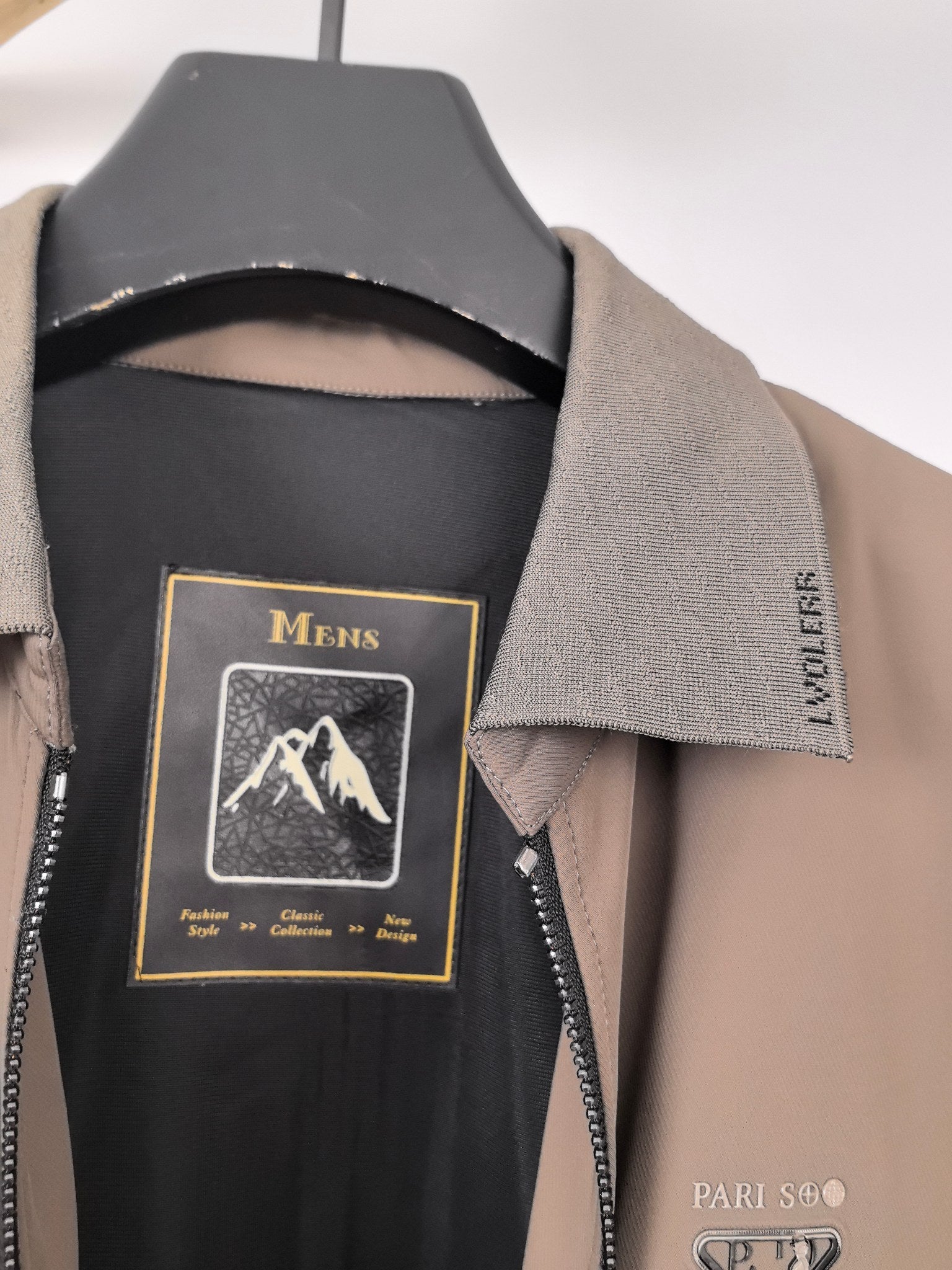 Men's Prada jacket neck label close-up with black inner lining and taupe collar