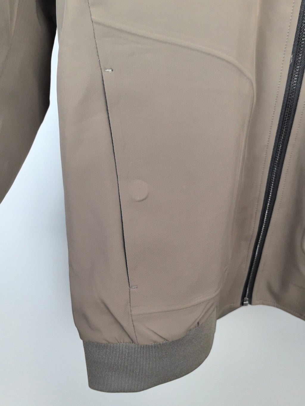 Men's Prada jacket interior panel view, taupe lining with vertical seam