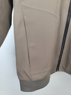 Men's Prada jacket interior panel view, taupe lining with vertical seam