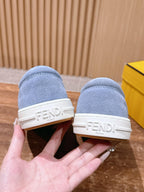 Light blue suede slip-on sneakers with blue fuzzy strap and FENDI logo on heel