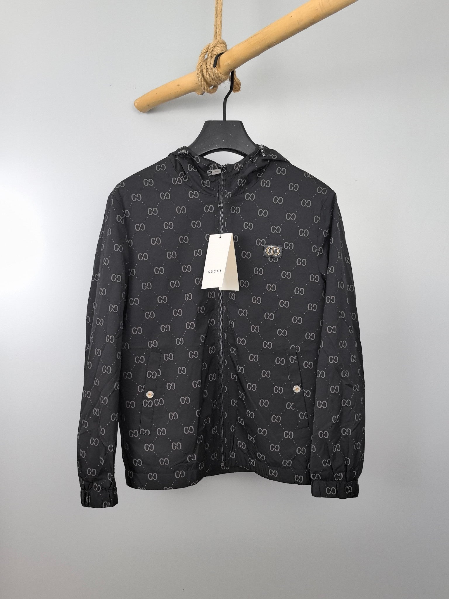 Gucci hooded jacket, dark gray with repeating GG pattern, front view