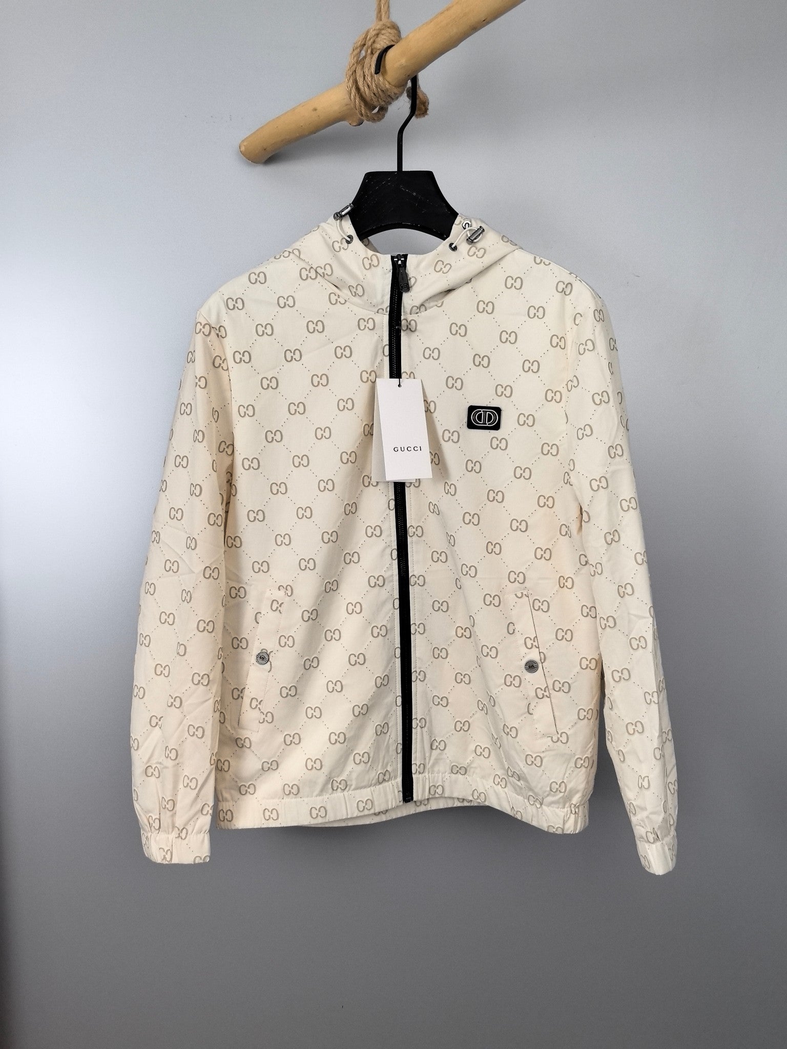 Cream long jacket with dark zipper and repeating GG monogram print