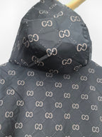 Gucci hooded jacket, dark gray with repeating GG pattern, draped shoulder view