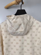 Cream long jacket back view with repeating GG monogram print and gathered hood