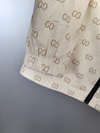 Cream long jacket hem with GG monogram pattern and dark trim