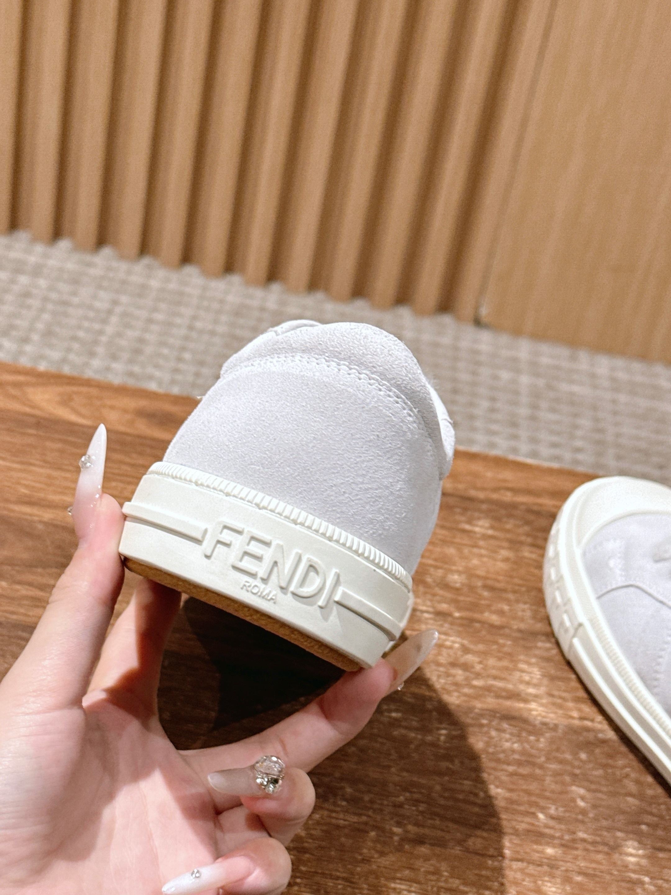 White Fendi sneakers heel view with Fendi logo band and rubber sole