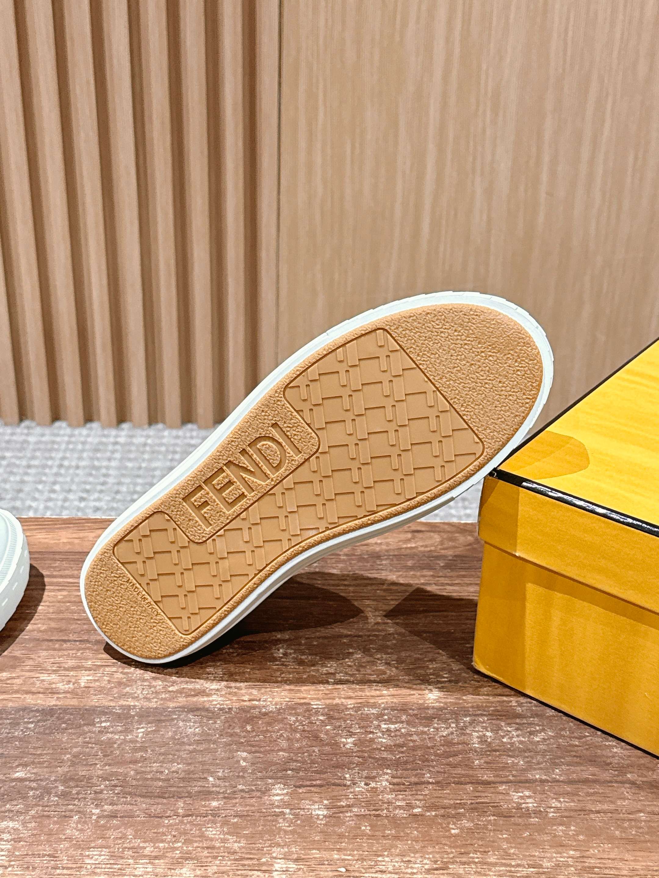 Tan Fendi sneaker outsole with embossed logo pattern and textured tread