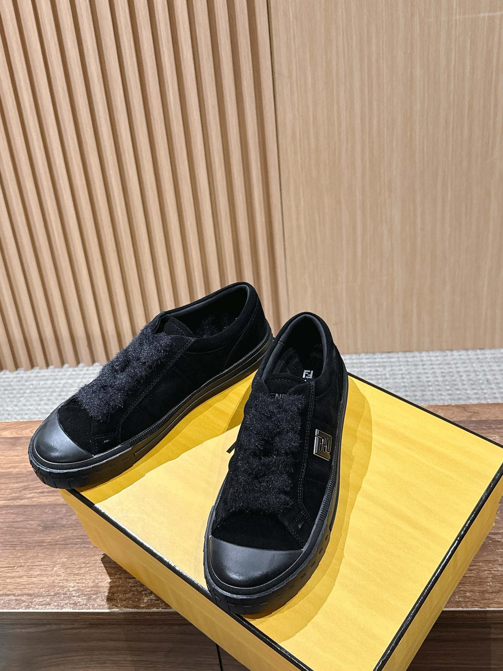 Black suede slip-on shoes with low rubber sole and stitched side panels