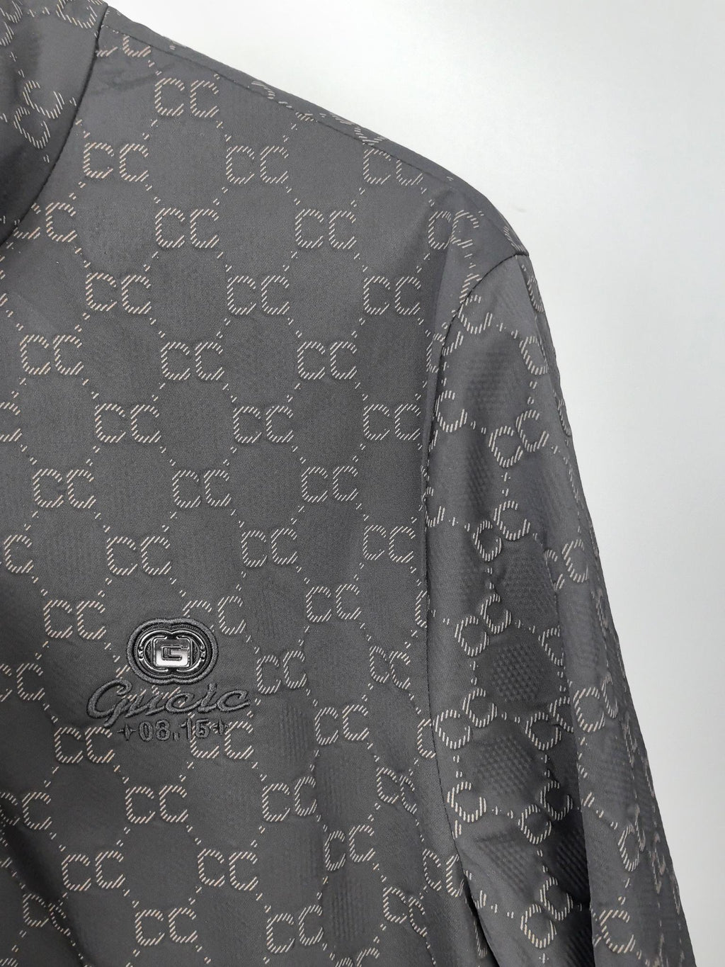 Gucci monogram zip jacket shoulder and upper sleeve with subtle fabric texture