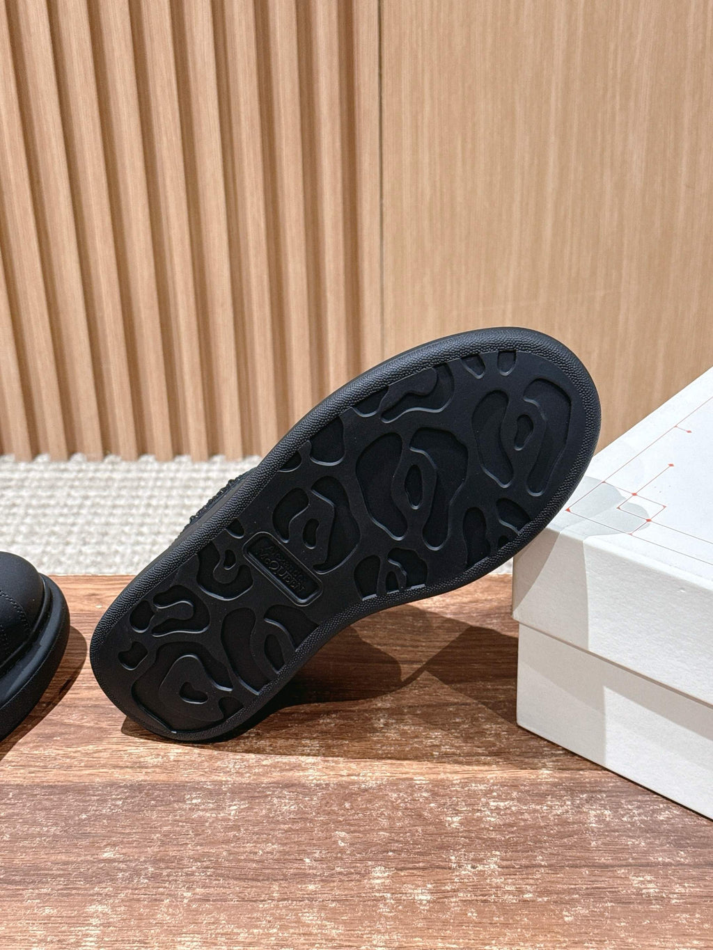 Black rubber outsole with molded tread pattern on low-top sneaker