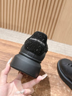 Black sneaker heel with glittery fabric overlay and logo patch