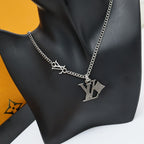 Silver LV pendant charm necklace with chain on black bust display