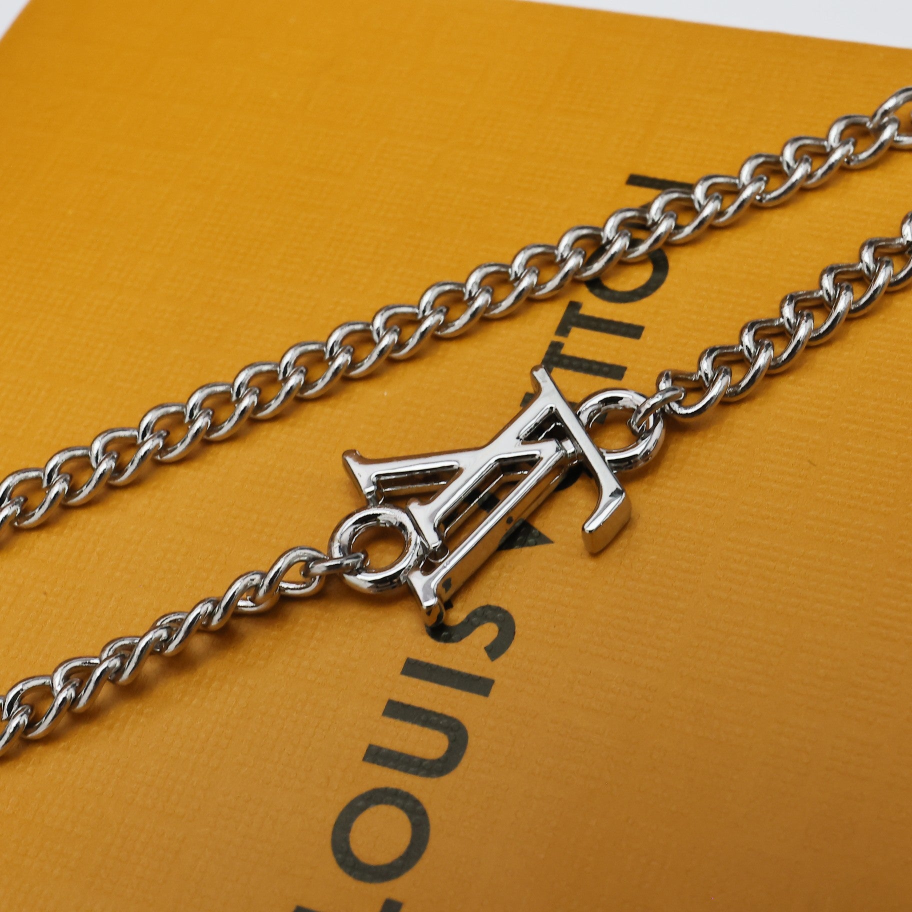 Silver chain necklace with small LV letter charm on chain