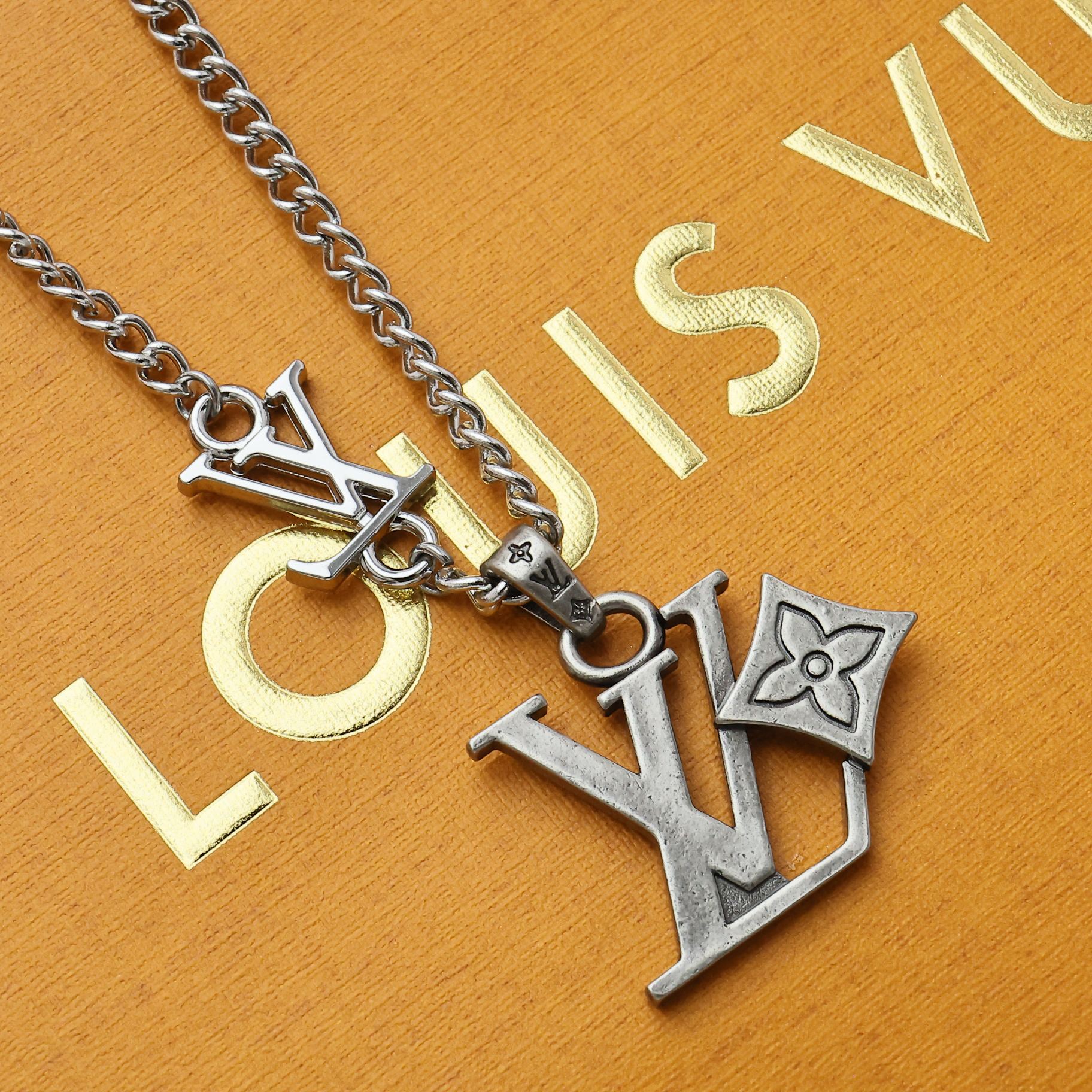 Silver tone charm necklace with LV pendant and letter charms