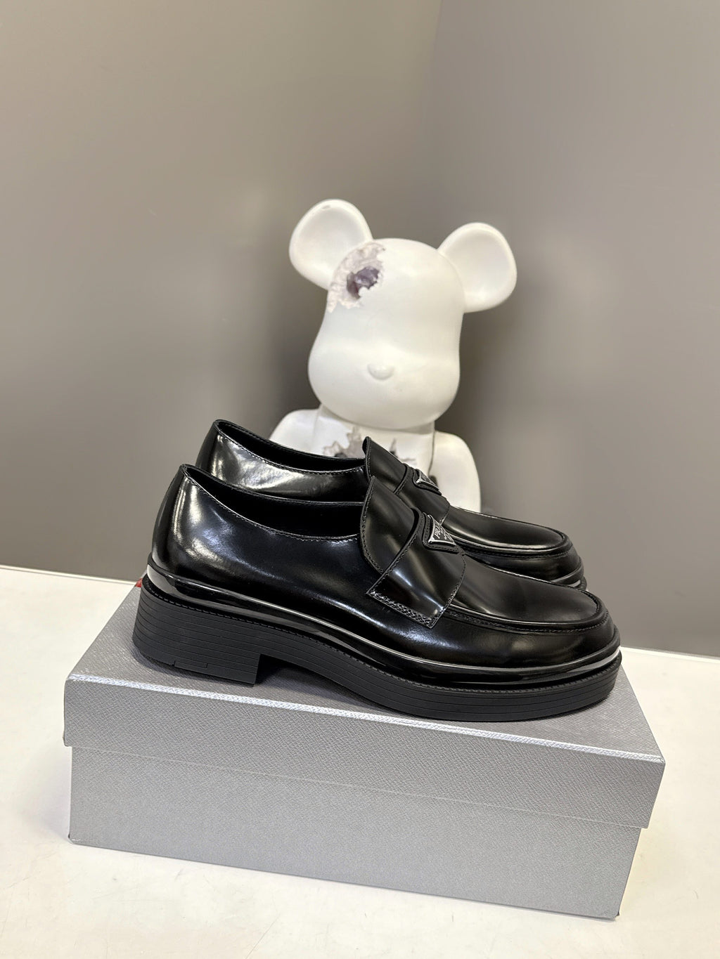 Prada unisex black leather loafers with thick platform sole and strap detailing
