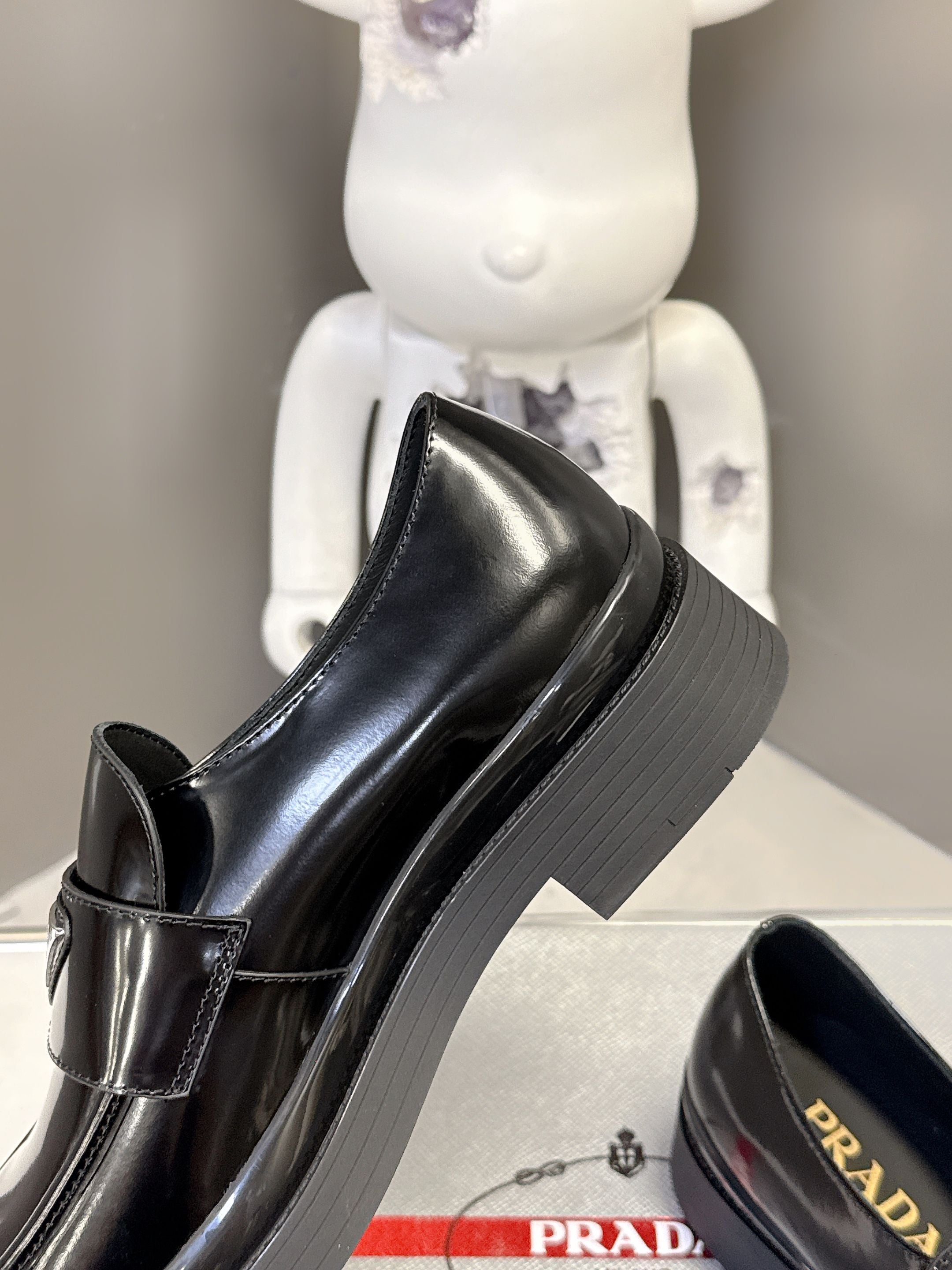 Prada unisex black leather loafer with stacked platform sole and side strap tab