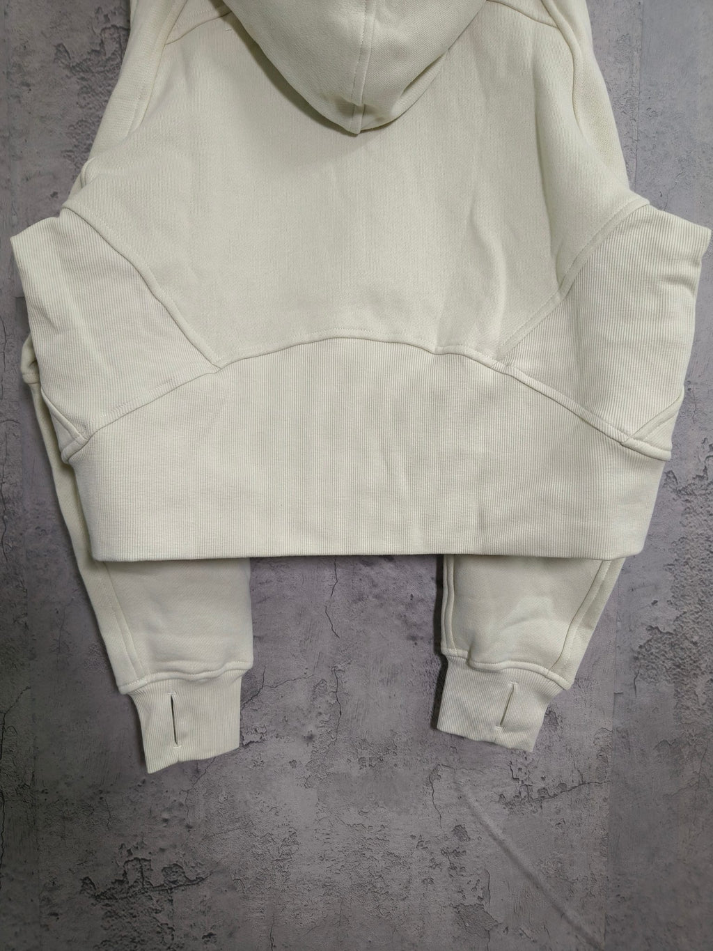 Cream zip-up hooded sweatshirt with kangaroo pocket and ribbed ankle-length cuffs
