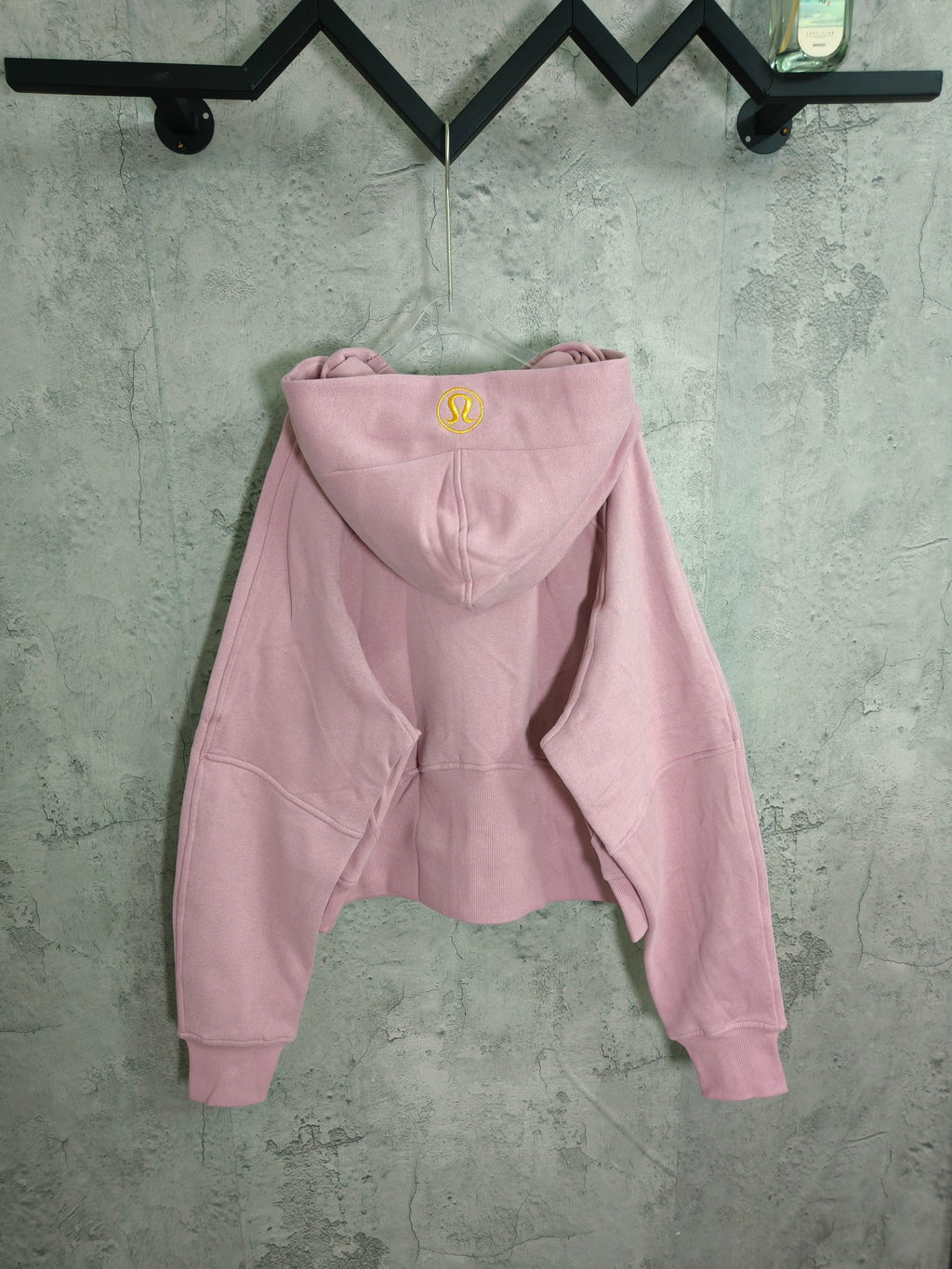 Light pink zip-up hoodie with hood and kangaroo pocket, long sleeves