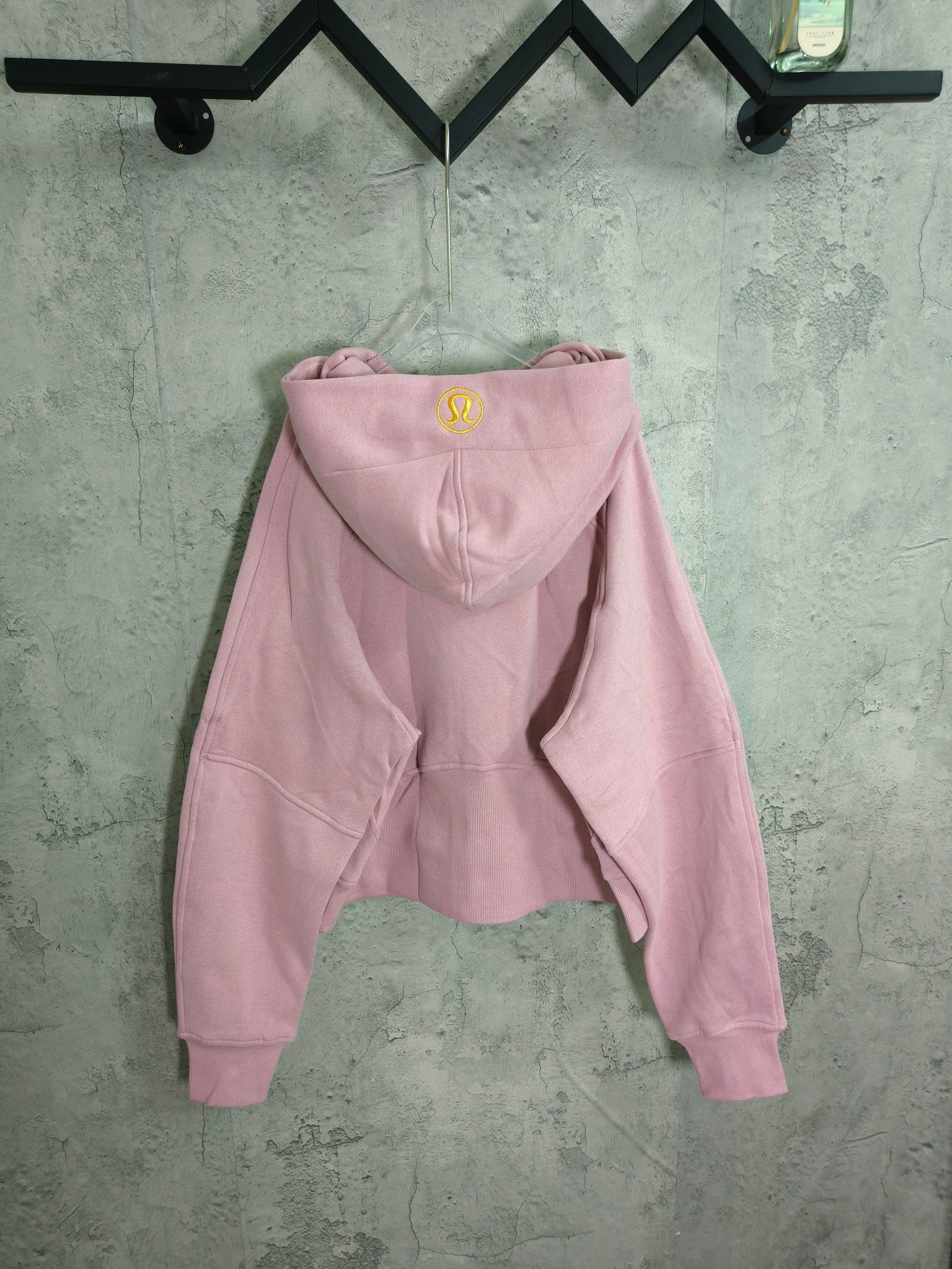 Light pink zip-up hoodie with hood and kangaroo pocket, long sleeves