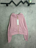 Light pink zip-up hoodie with hood, front pockets, and full-length zipper