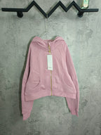 Light pink zip-up hooded sweatshirt with kangaroo pocket and long sleeves