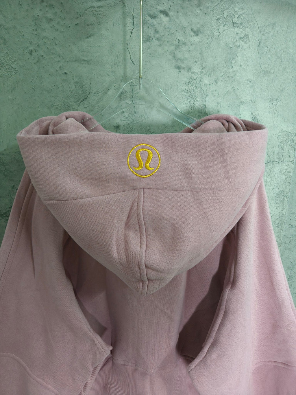 Light pink zip-up hooded sweatshirt back with hood logo and kangaroo pocket