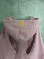 Light pink zip-up hooded sweatshirt back with hood logo and kangaroo pocket