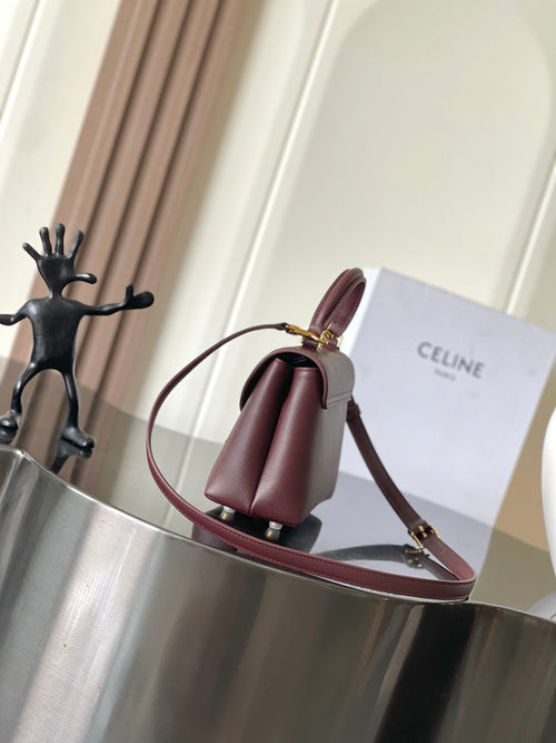 Celine top-handle bag with rolled handles, burgundy leather, and gold hardware.