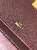 Celine Paris embossed on burgundy leather with visible edge stitching.