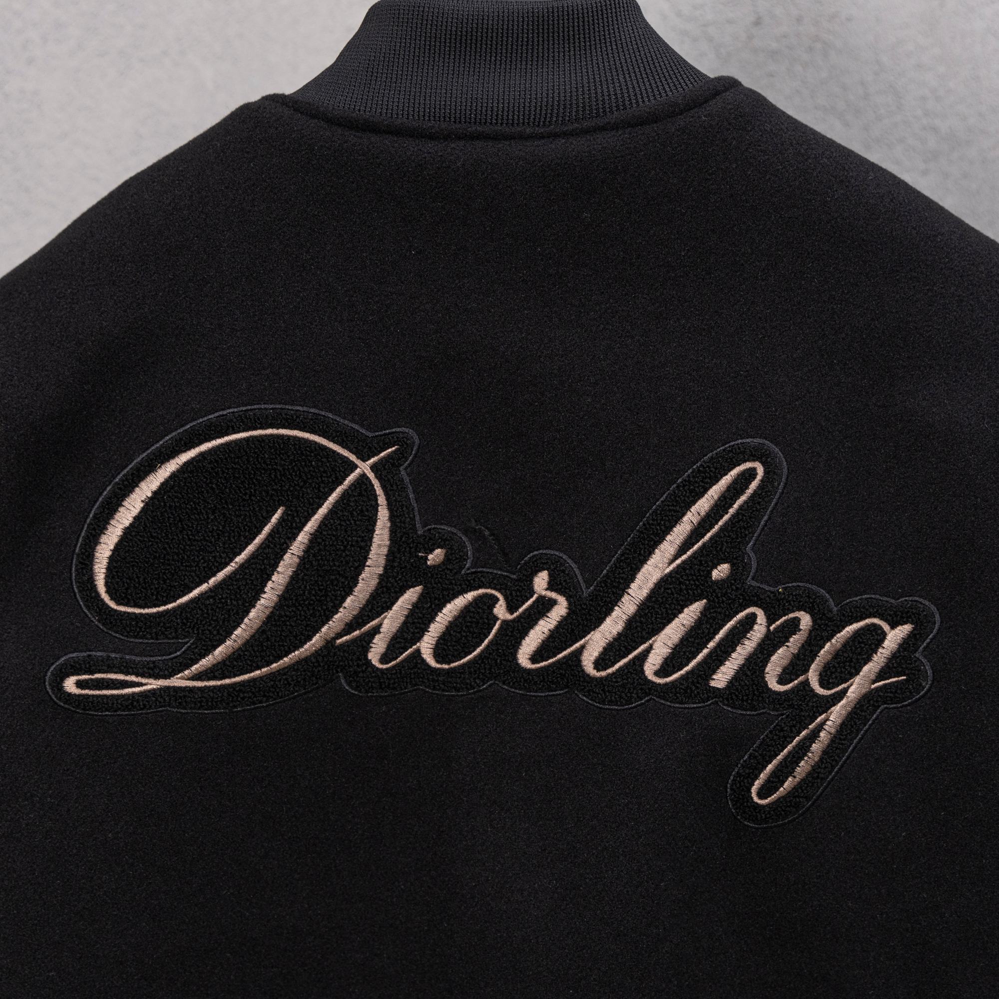 Black jacket with large Diorling cursive logo on back