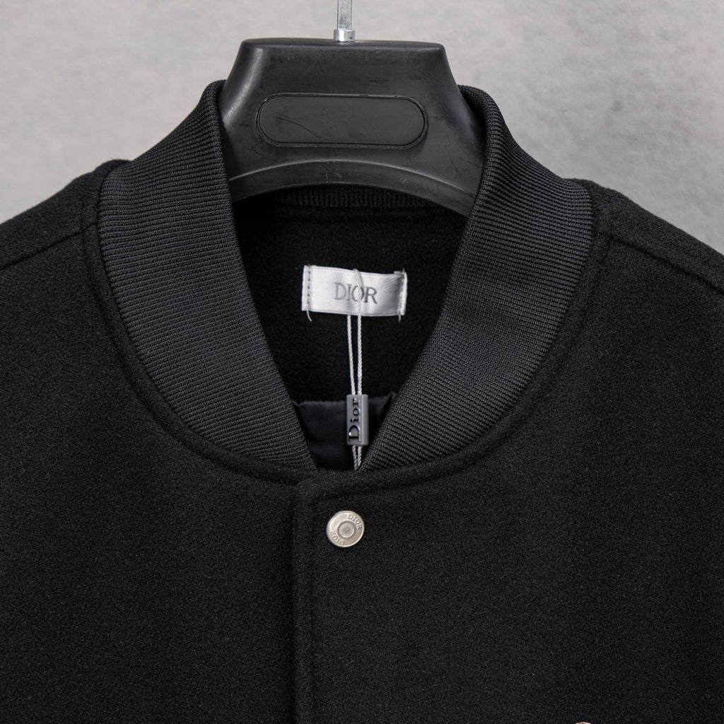 Black long-sleeve jacket with ribbed collar and DIOR label at neck