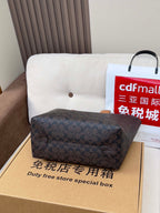 COACH patterned satchel bag, dark navy, on top of duty free special box