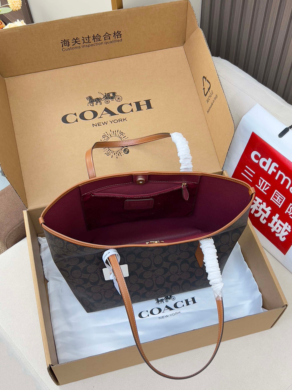 COACH tote bag interior, burgundy lining with hardware, navy exterior, in gift box