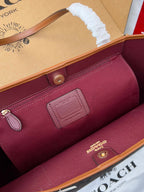 COACH burgundy tote interior with leather trim, snap pocket, and embossed logo patch