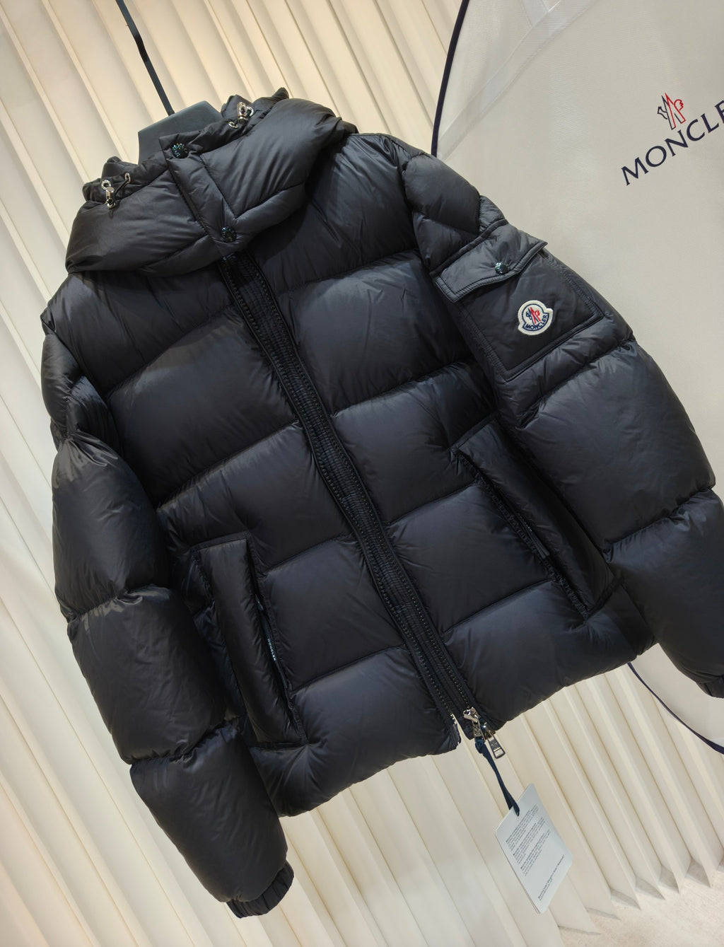 Moncler long padded jacket, dark quilted puffer, hooded neckline, sleeve logo patch