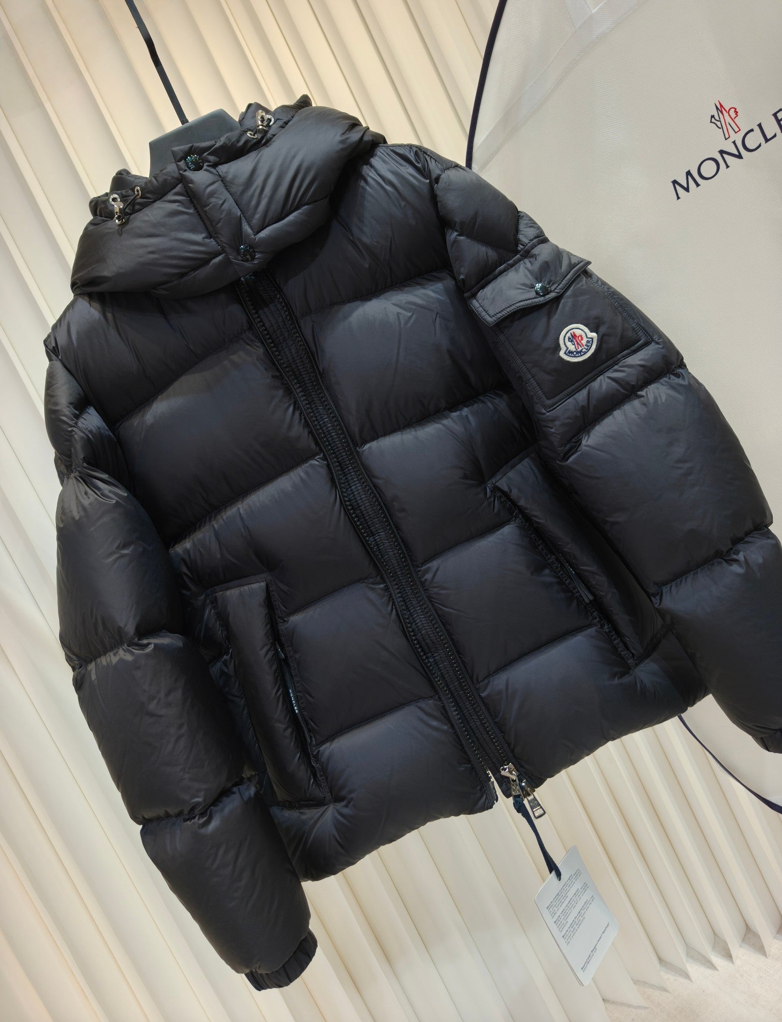Moncler long padded jacket, dark quilted puffer, hooded neckline, sleeve logo patch