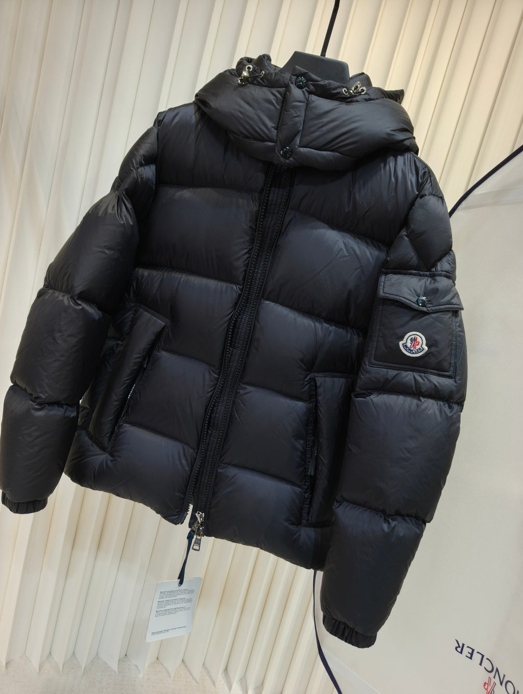 Moncler long padded jacket, dark quilted puffer with hood and zip front, sleeve patch