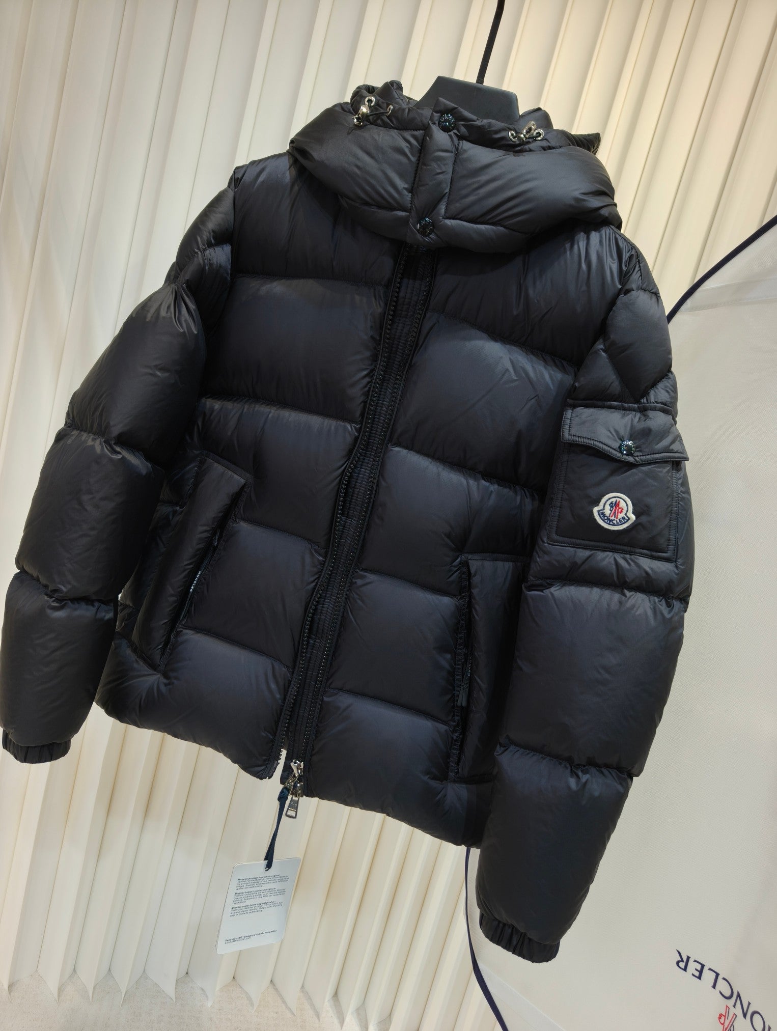 Moncler long padded jacket, dark quilted puffer with hood and zip front, sleeve patch