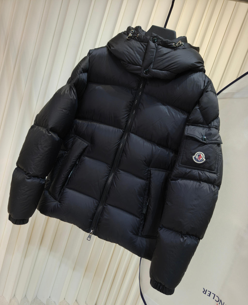 Moncler long padded jacket in dark color, quilted puffer with hood and zip front