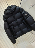 Moncler long padded jacket in dark color, quilted puffer with hood and side sleeve patch