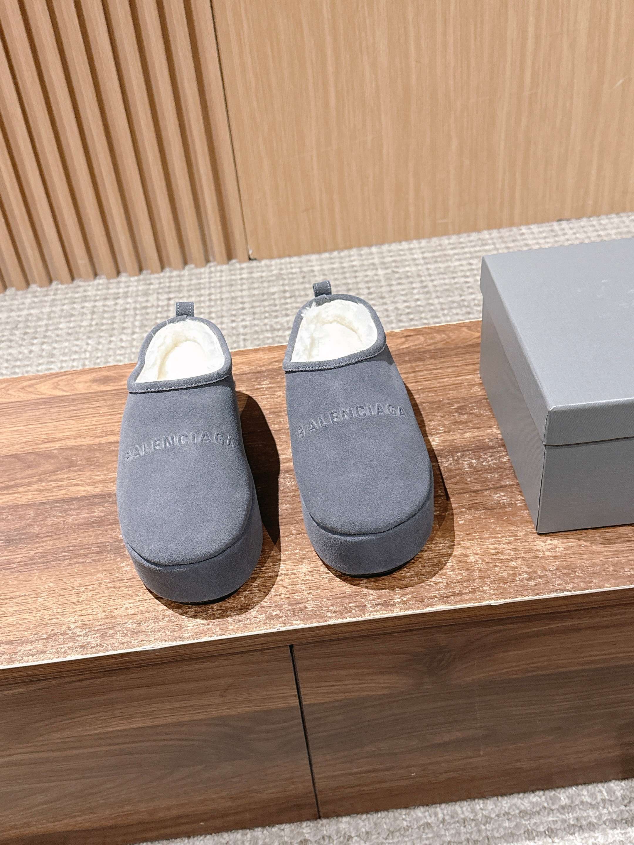 Grey Balenciaga slide sandals with open back and cushioned footbed, pair shown