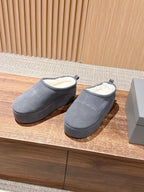 Grey Balenciaga slide sandals with open back, side view, pair on display