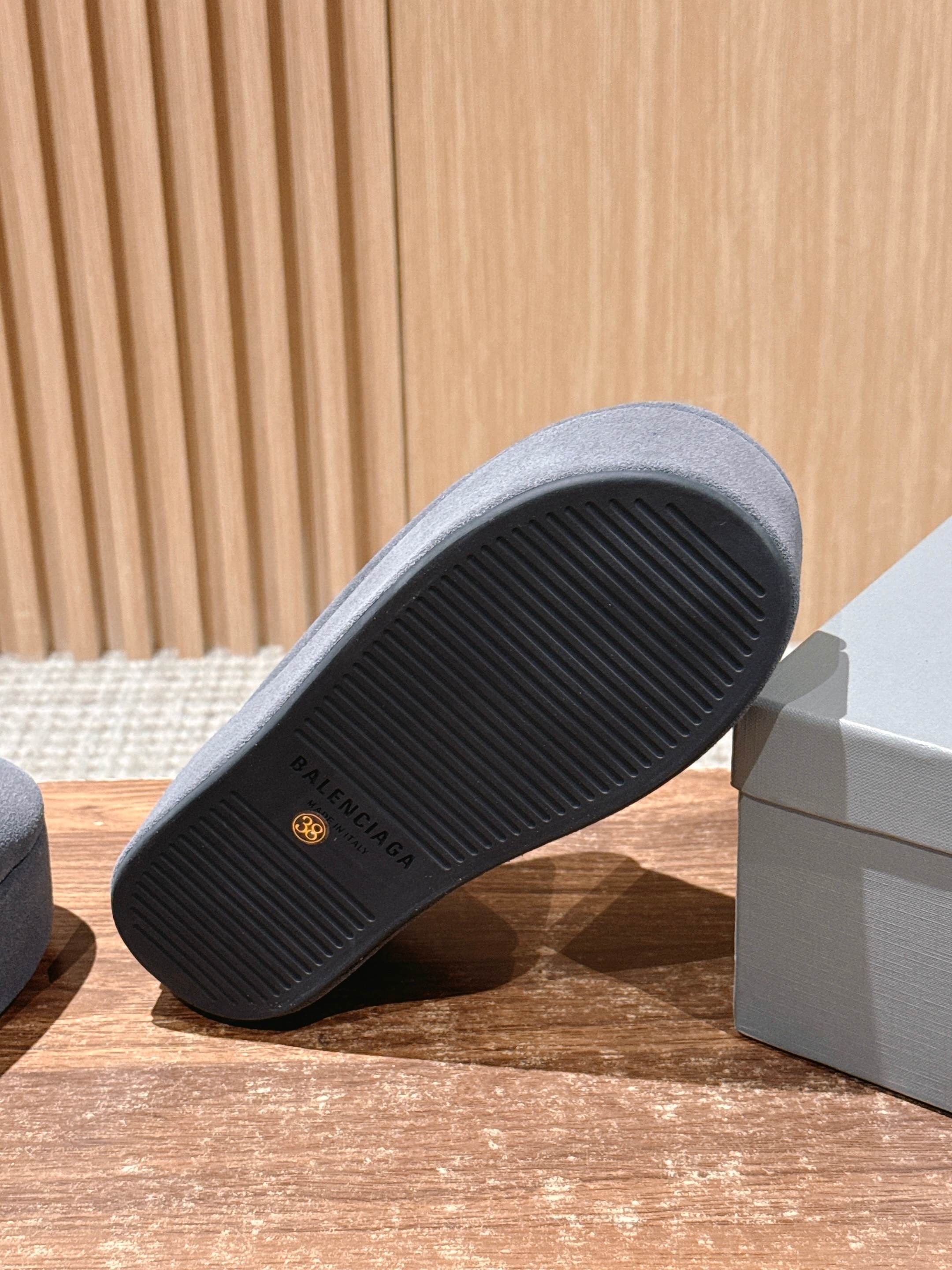 Grey Balenciaga slide sandal outsole close-up with ridged tread