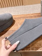 Grey Balenciaga slide sandal side view, wide strap with small metal eyelet