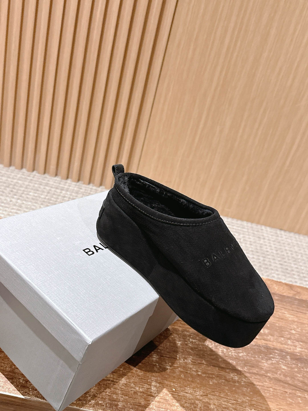 Black Balenciaga slip-on sandals on white box, rounded toe and cuff