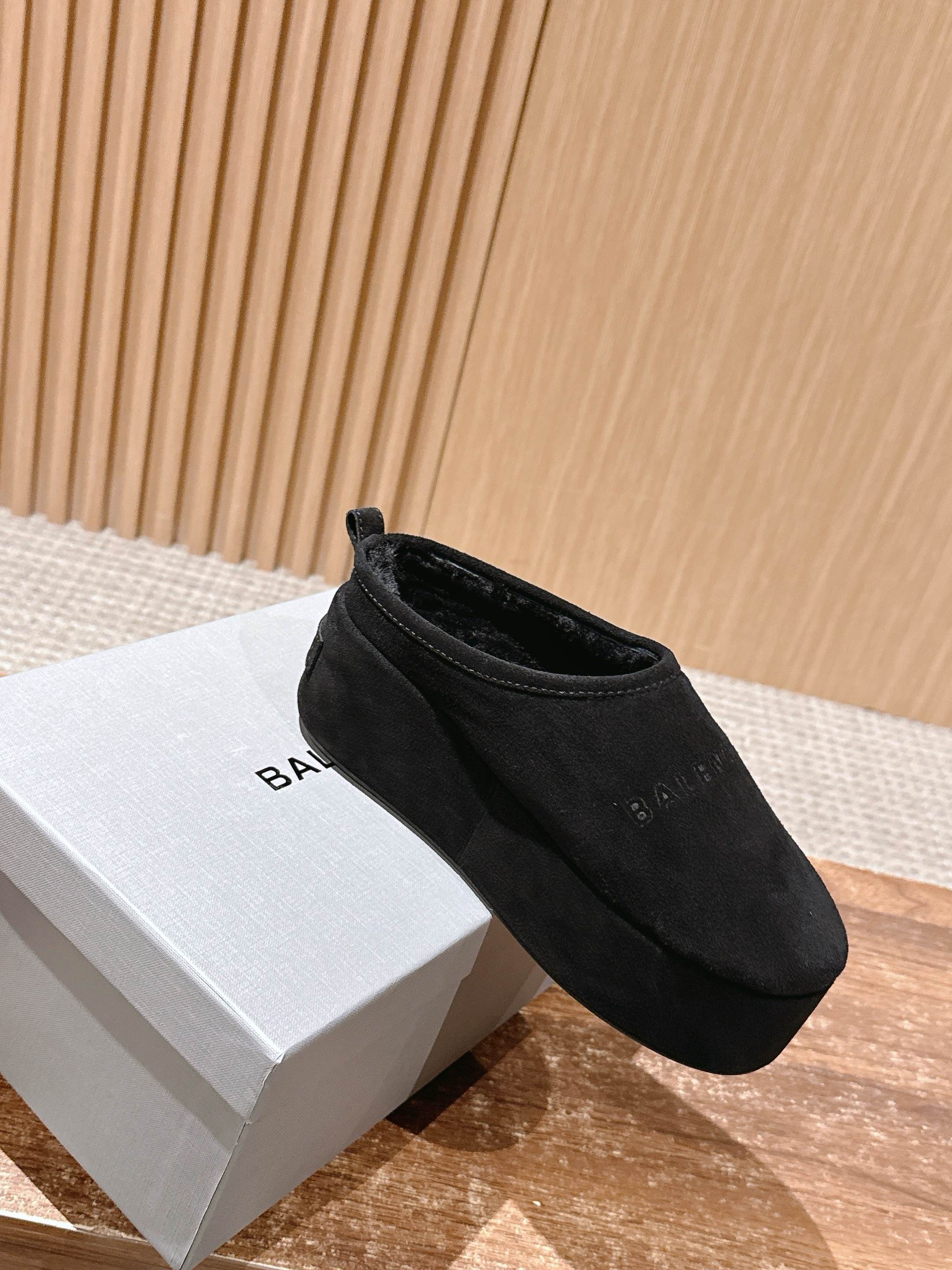 Black Balenciaga slip-on sandals on white box, rounded toe and cuff