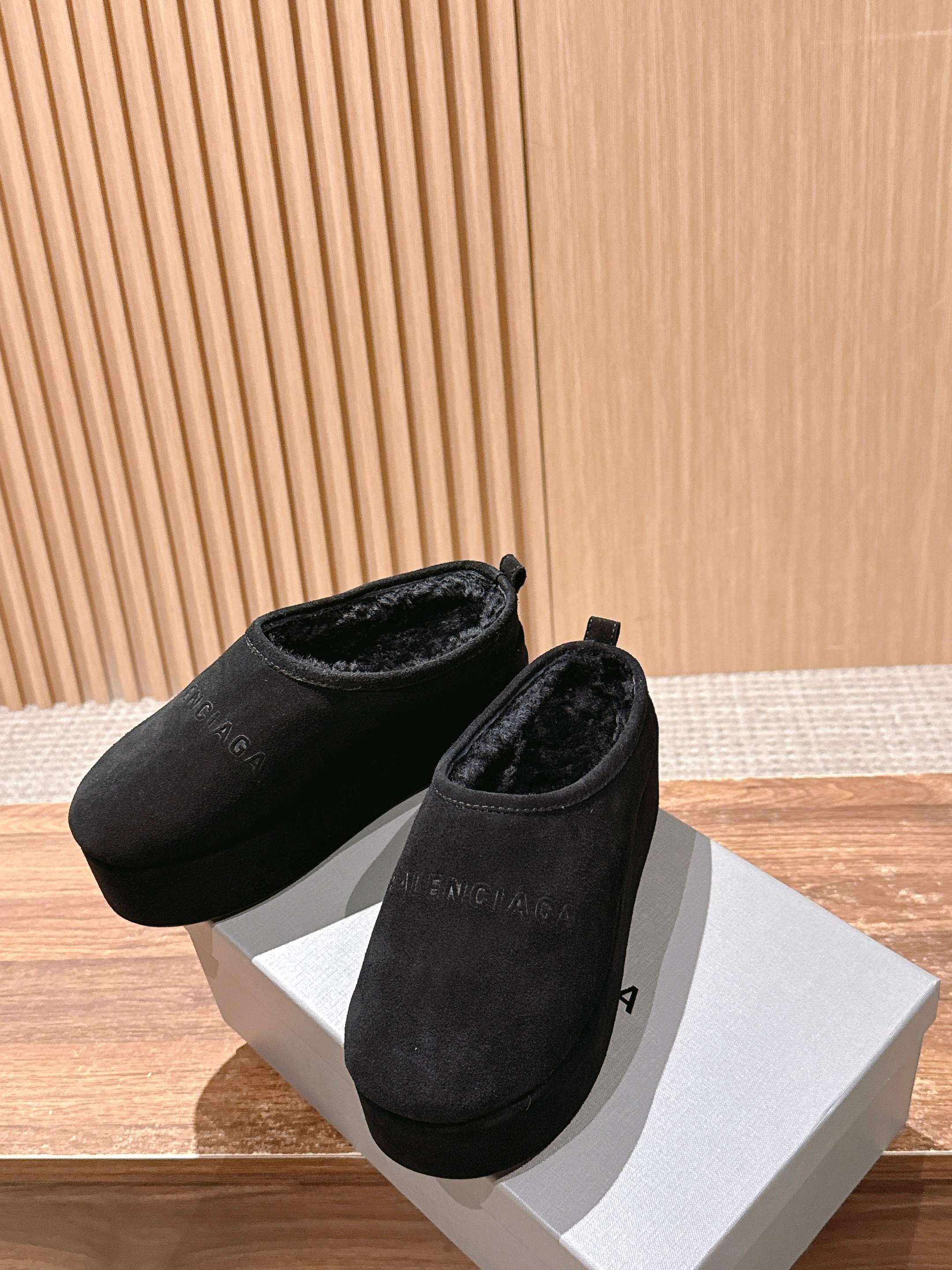 Balenciaga black suede slide sandals, pair with rounded toe, on white box.